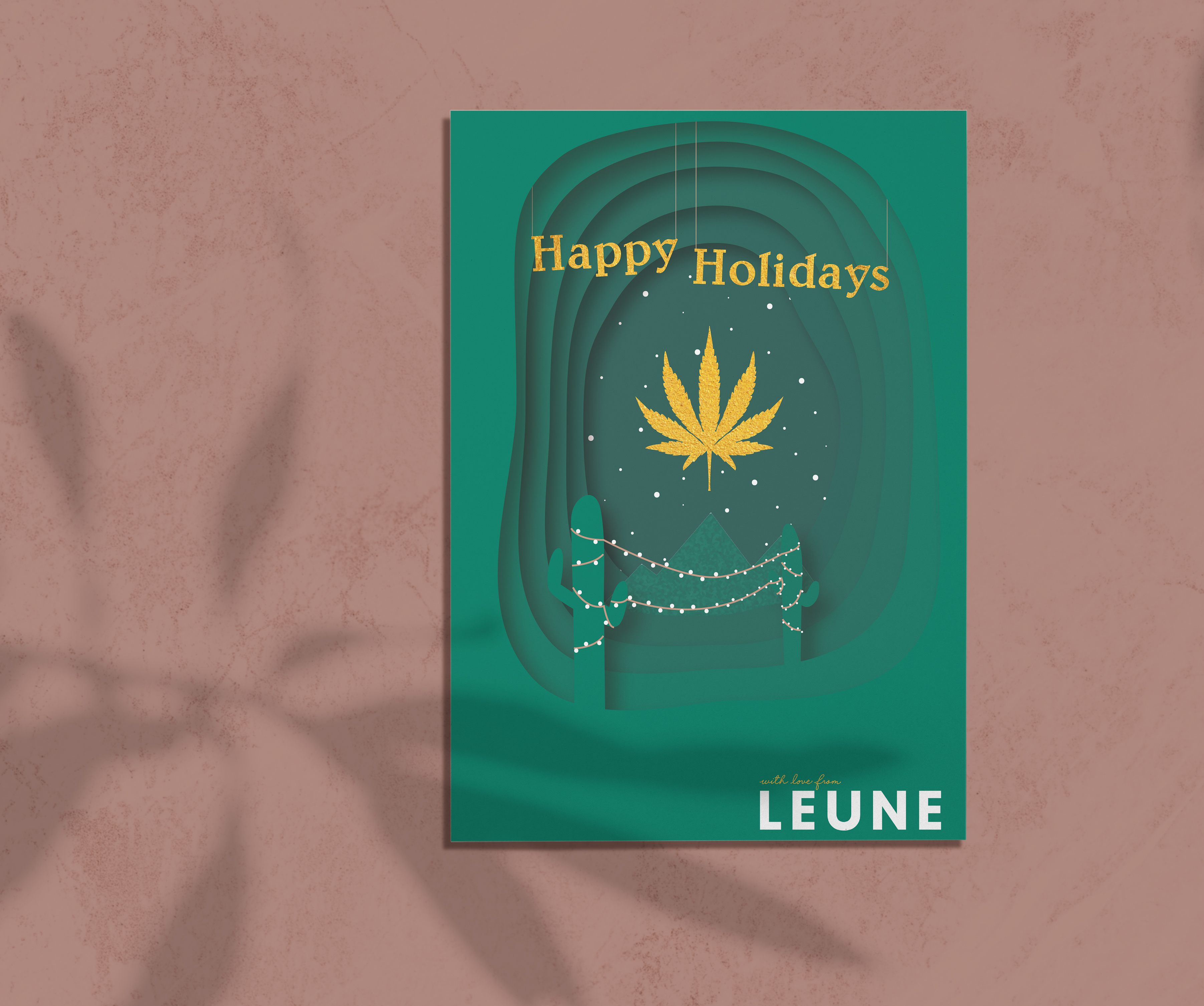 Cut paper holiday card with cacti and mountains